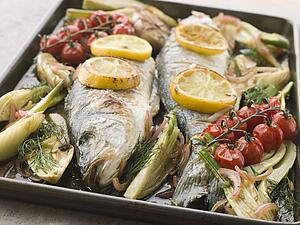 Whole Sea Bass Roasted with Fennel Lemon Garlic and Cherry Tomatoes on the Vine