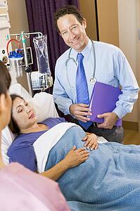 Doctor Standing In Patients Room