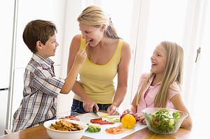Mother And Children Prepare A meal, mealtime Together 