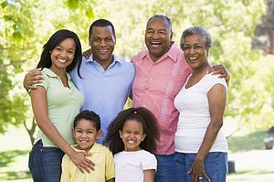 Extended family standing in park smiling