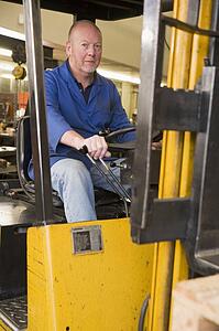 Warehouse worker in forklift