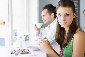 Young couple having tea in a cafeteria