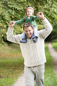 Father giving baby son piggyback