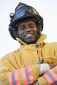 Fireman standing outdoors wearing helmet