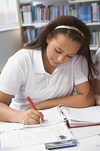 Student writing and studying