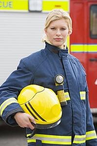 Firewoman standing by fire engine