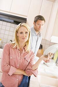 Husband And Wife Doing Dishes