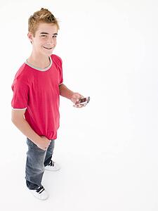 young boy holding cellular phone and smiling