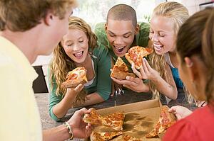 Group Of Teenagers Eating Pizza 