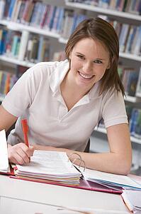 Student writing and studying