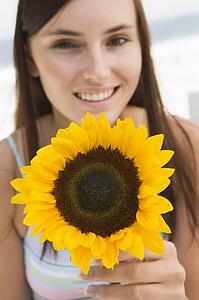 Woman holding a sunflower