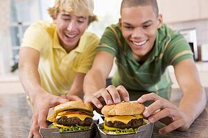 Teenage Boys Eating Burgers