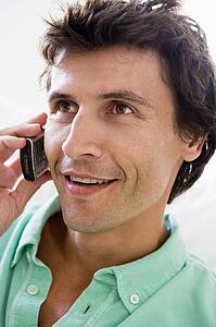 Man using cellular phone and smiling