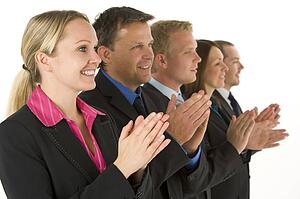 Group Of Business People In A Line Smiling And Applauding