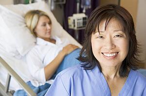 Doctor Standing In Patients Room, Smiling
