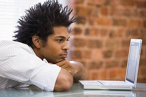 Businessman sitting in office with laptop