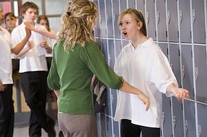 Female teacher reprimanding a female student