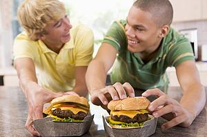 Teenage Boys Eating Burgers 
