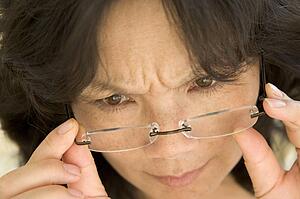 Woman Looking Through New Glasses