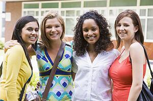 Group of students outdoors looking at camera smiling