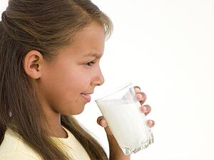 Young girl with glass of milk smiling