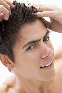 Man playing with hair smiling