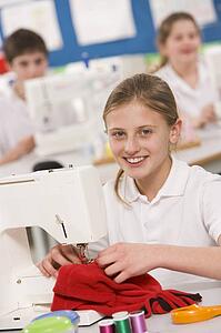 Female student using sewing machine