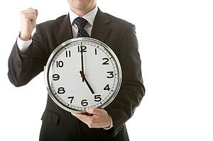 Businessman Holding Clock 