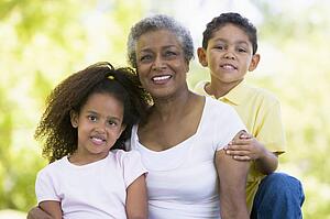Grandmother posing with grandchildren.