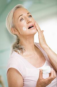 Woman applying face cream