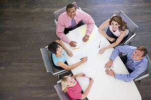 Five businesspeople at boardroom table