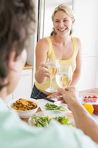 Woman Talking To Husband While Preparing meal, mealtime