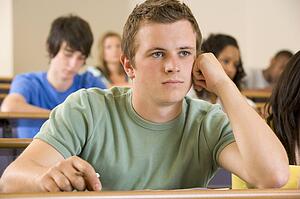 Student in class bored (selective focus)