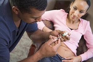 Man helping woman inject drugs to gain pregnancy (selective focus)