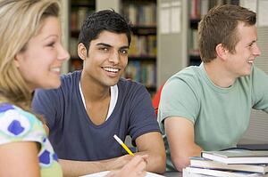 Three people in library studying (selective focus)