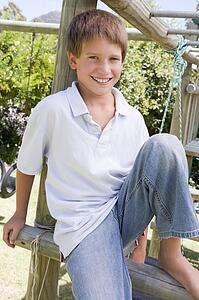 Young boy at a playground smiling