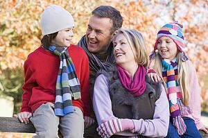 Grandparents with grandchildren outdoors in park smiling (selective focus)