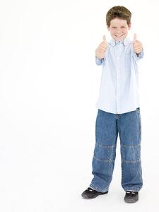 Young boy giving thumbs up smiling