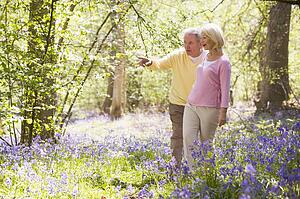Couple walking outdoors pointing and smiling