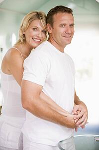 Couple in bathroom embracing and smiling