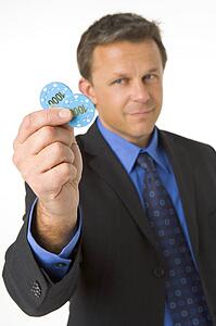 Businessman Holding Poker Chips To The Value Of $2000