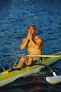 Kayakers sitting in kayak and splashing water on face (selective focus)