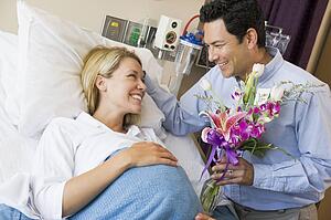 Man Giving His Pregnant Wife Flowers