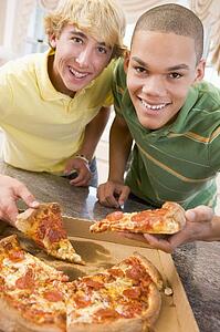 Teenage Boys Eating Pizza 