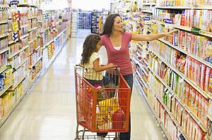 Mother and young daughter shopping at a grocery store