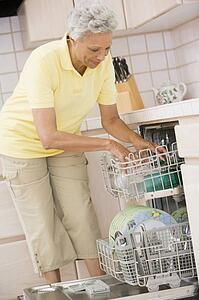 Woman Loading Dishwasher 