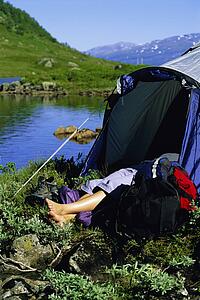 Camper outdoors sleeping at campsite by lake