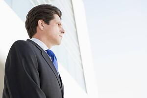 Businessman standing outdoors by building
