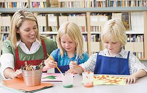 Two students in art class with teacher