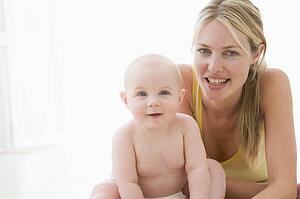 Mother and baby indoors smiling